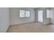 Bedroom featuring neutral carpet, a window, and access to a private patio at 2681 Ruthe Duarte Ave, Las Vegas, NV 89121