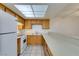 Bright kitchen with wooden cabinets, white appliances, and a breakfast bar at 2681 Ruthe Duarte Ave, Las Vegas, NV 89121
