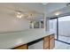 Kitchen with wooden cabinets, stainless steel dishwasher, and sliding glass door to patio at 2681 Ruthe Duarte Ave, Las Vegas, NV 89121