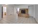 Open living room featuring a cozy brick fireplace, tile floors, and natural light at 2681 Ruthe Duarte Ave, Las Vegas, NV 89121