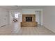 Spacious living room featuring a brick fireplace and tile flooring, with stairs leading to the upper level at 2681 Ruthe Duarte Ave, Las Vegas, NV 89121