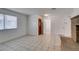 A bright living room with tile flooring, a large window, and a decorative front door at 2681 Ruthe Duarte Ave, Las Vegas, NV 89121