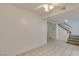 A bright living area with tile floors and stairs leading to the upper level of the home at 2681 Ruthe Duarte Ave, Las Vegas, NV 89121