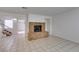 Spacious living room with a cozy brick fireplace and tiled flooring; awaiting your personal touch at 2681 Ruthe Duarte Ave, Las Vegas, NV 89121