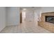 A bright living room with tile flooring, a staircase, and a brick fireplace at 2681 Ruthe Duarte Ave, Las Vegas, NV 89121
