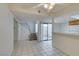 Spacious living area with tile flooring, stairs leading to the second story, and slider to outdoor patio at 2681 Ruthe Duarte Ave, Las Vegas, NV 89121