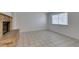Cozy living room featuring a brick fireplace, large window, and tile flooring at 2681 Ruthe Duarte Ave, Las Vegas, NV 89121