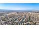 Wide aerial shot displays the layout of a desert residential area, with a backdrop of distant mountains and a clear blue sky at 2727 Chinaberry Hill St, Laughlin, NV 89029