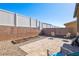 Paver patio and gravel landscaping in backyard with low-maintenance design and tall fencing for privacy at 2727 Chinaberry Hill St, Laughlin, NV 89029