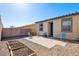 Private backyard with paver patio, low-maintenance landscaping, planting beds, and block and vinyl fencing at 2727 Chinaberry Hill St, Laughlin, NV 89029