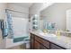 Bathroom with a shower-tub combo, granite counters and floating shelves for convenient towel storage at 2727 Chinaberry Hill St, Laughlin, NV 89029