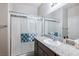 Bathroom vanity with granite counters, a glass shower door, and a large mirror for natural light at 2727 Chinaberry Hill St, Laughlin, NV 89029