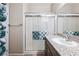 Bathroom features floating shelves of rolled towels, a walk-in shower, and a granite vanity countertop at 2727 Chinaberry Hill St, Laughlin, NV 89029