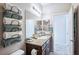 Bathroom featuring granite countertops, a large vanity mirror, and floating towel storage at 2727 Chinaberry Hill St, Laughlin, NV 89029