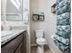 Bathroom featuring a toilet, floating shelves, granite countertop and rolled towels for decoration and storage at 2727 Chinaberry Hill St, Laughlin, NV 89029
