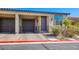 Attractive townhouse showcasing a convenient one-car garage and well-maintained landscaping at 2727 Chinaberry Hill St, Laughlin, NV 89029