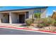 Inviting townhouse featuring a one-car garage, desert landscaping, and a quaint front entrance at 2727 Chinaberry Hill St, Laughlin, NV 89029