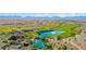 Aerial view showcasing a golf course and clubhouse featuring a tranquil pond and manicured greens at 2727 Chinaberry Hill St, Laughlin, NV 89029
