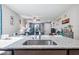 Open-concept kitchen island with granite countertop flows into the living area, great for entertaining guests at 2727 Chinaberry Hill St, Laughlin, NV 89029