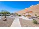 Community splash pad features a colorful rainbow water feature, picnic tables with sunshades and desert landscaping at 2727 Chinaberry Hill St, Laughlin, NV 89029