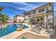 Backyard with pool and waterfall feature, plus covered patio and spiral staircase at 2749 Carolina Blue Ave, Henderson, NV 89052