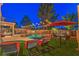 Inviting backyard features a sparkling pool, lounge chairs, and ambient string lights, perfect for outdoor relaxation at 2749 Carolina Blue Ave, Henderson, NV 89052