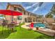 The lush backyard features a pool, waterfall, dining set and covered patio, perfect for entertaining at 2749 Carolina Blue Ave, Henderson, NV 89052