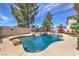 Sparkling pool with beautiful rock waterfall feature, lounge chairs and backyard at 2749 Carolina Blue Ave, Henderson, NV 89052