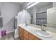 Bathroom with dual sink, natural wood cabinets, neutral color scheme, and bathtub shower combo at 2749 Carolina Blue Ave, Henderson, NV 89052