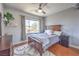 Bedroom with hardwood floors, decorative shelves, dark furniture, and plenty of natural light at 2749 Carolina Blue Ave, Henderson, NV 89052