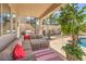 A covered patio is showcased, featuring cozy furniture, a grill and decor at 2749 Carolina Blue Ave, Henderson, NV 89052