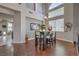 Open-concept dining area with stylish table and chairs, hardwood floors, and high ceilings at 2749 Carolina Blue Ave, Henderson, NV 89052
