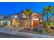 Inviting two-story home with mature palms, decorative stone landscaping, and a spacious three-car garage at 2749 Carolina Blue Ave, Henderson, NV 89052