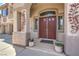 Elegant front entry with double doors, arched transom window, and decorative sconces at 2749 Carolina Blue Ave, Henderson, NV 89052