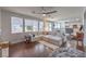 Spacious living room with a comfortable sectional sofa, ceiling fan, and adjacent kitchen area at 2749 Carolina Blue Ave, Henderson, NV 89052