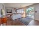 Cozy living room featuring a fireplace, ceiling fan, and sliding glass doors leading to a pool at 2749 Carolina Blue Ave, Henderson, NV 89052