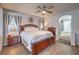 Comfortable bedroom features a king-sized bed, wood floors, and an ensuite bathroom at 2749 Carolina Blue Ave, Henderson, NV 89052