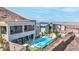 Aerial view of the home showcasing the pool, spa, waterfall feature, outdoor bar, and city views at 286 Shaded Canyon Dr, Henderson, NV 89012