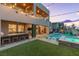 Gorgeous backyard showcasing a pool, spa, waterfall feature, outdoor bar, and home at 286 Shaded Canyon Dr, Henderson, NV 89012