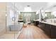 Luxurious bathroom featuring a freestanding tub, glass shower, and double vanity sinks at 286 Shaded Canyon Dr, Henderson, NV 89012