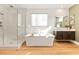 Modern bathroom with a soaking tub, separate glass shower, and elegant fixtures at 286 Shaded Canyon Dr, Henderson, NV 89012