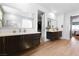 Bathroom featuring double sinks with undermount lighting, wood floors and a peek at the bedroom at 286 Shaded Canyon Dr, Henderson, NV 89012