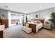 Bright bedroom with a large bed, stylish decor, and a private balcony overlooking a scenic landscape at 286 Shaded Canyon Dr, Henderson, NV 89012