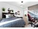 Cozy bedroom with a comfortable bed, decorative wall art, gaming chair, and modern lighting at 286 Shaded Canyon Dr, Henderson, NV 89012