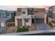 Contemporary two-story home featuring a modern design, stone accents, a well-manicured yard, and an attached garage at 286 Shaded Canyon Dr, Henderson, NV 89012