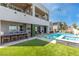 Modern home exterior with a luxurious pool, artificial turf, outdoor bar, and a multi-story design at 286 Shaded Canyon Dr, Henderson, NV 89012