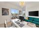 A modern home office with bright light, a desk and comfortable velvet sofa at 286 Shaded Canyon Dr, Henderson, NV 89012