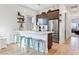 Modern kitchen bar with light counter, decorative cabinetry and new stainless fridge at 286 Shaded Canyon Dr, Henderson, NV 89012