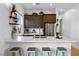 Bright kitchen features a waterfall countertop, dark wood cabinetry, and stainless appliances at 286 Shaded Canyon Dr, Henderson, NV 89012