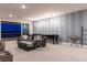 Spacious living room with a large sofa, shuffleboard table and sliding glass doors with stunning city views at 286 Shaded Canyon Dr, Henderson, NV 89012